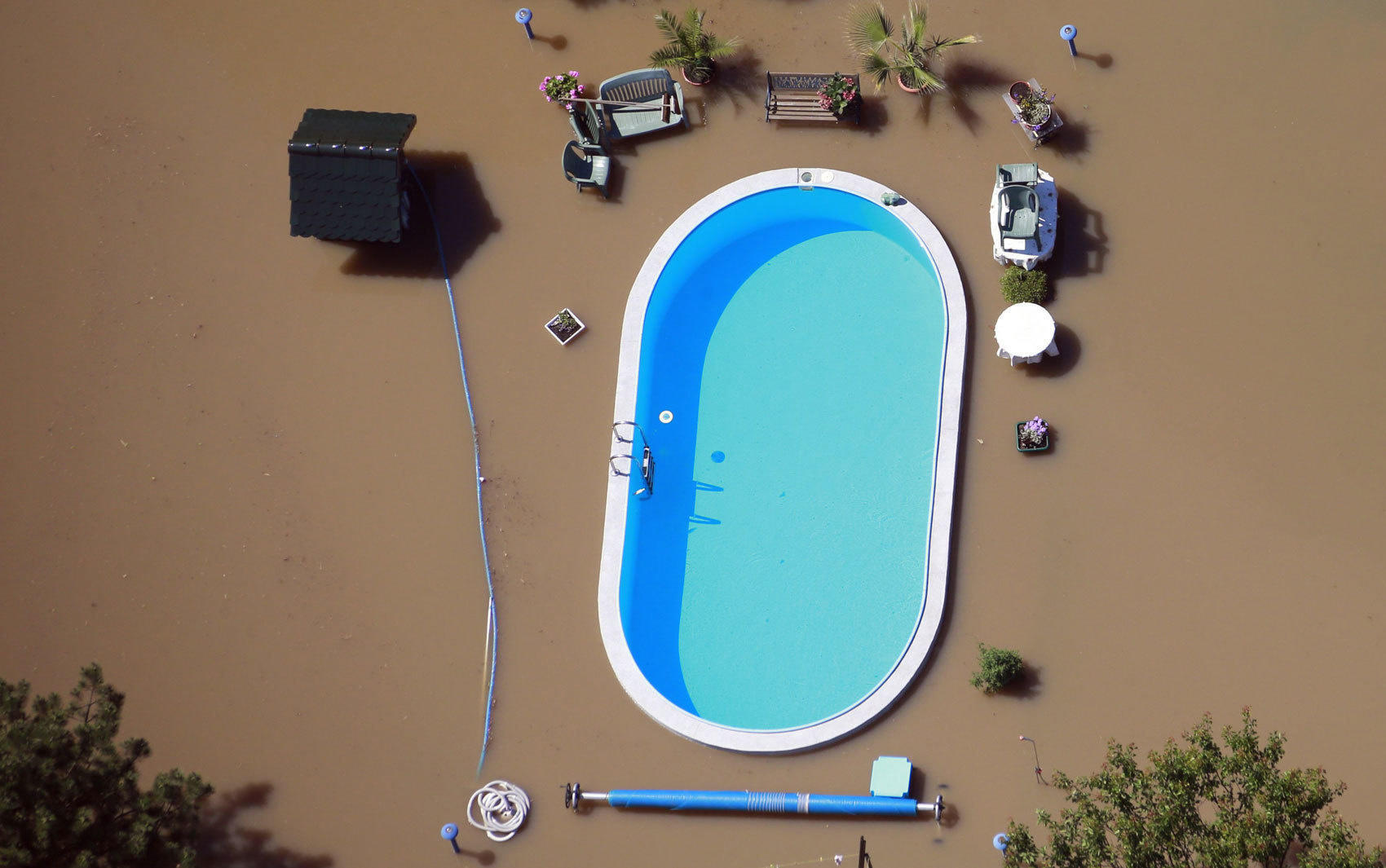 During this flood, the flood water almost spilled over into someone's pool,but didn't. 