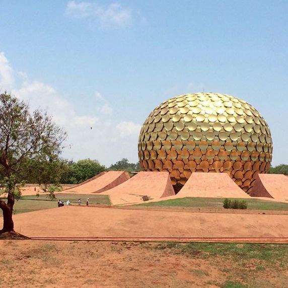 There's an experimental township in India called Auroville. There, citizens are from all over the world and there's no money or religion.