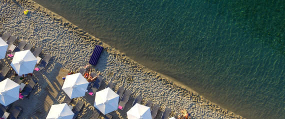 HALKIDIKI, GREECE - JUNE 23: Aerial view of The Pefkochori beach with umbrellas on June 23, 2015 in Halkidiki, Greece. Pefkochori is a tourist town located in the southeast of the peninsula of Kassandra and named after the pine trees which are abundant in the mountains of the area. (Photo by Athanasios Gioumpasis/Getty Images)