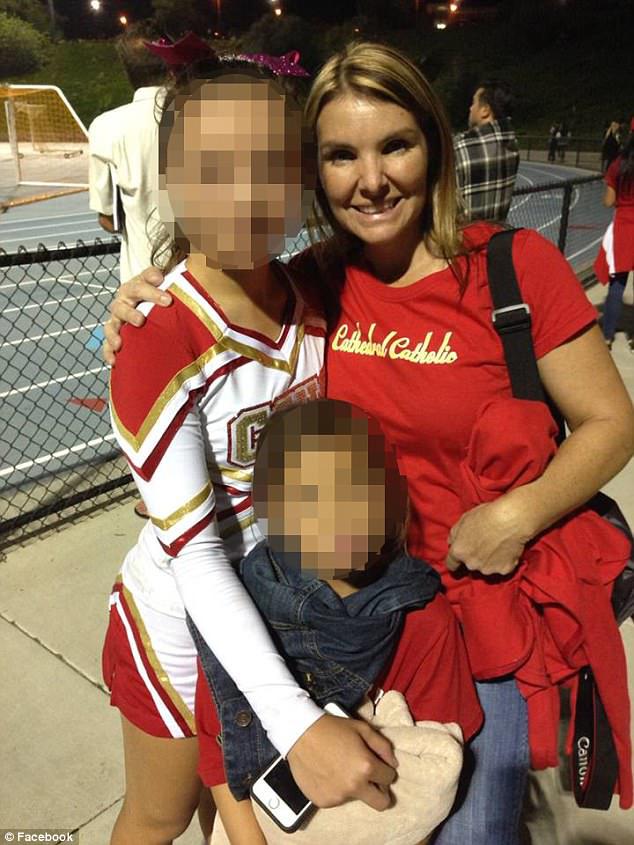 Kimberly Quach, 48, is pictured wearing a Cathedral Catholic High School shirt alongside her daughter in her cheer uniform