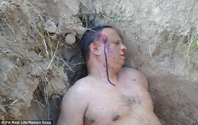 The 50-year-old boxing coach released dramatic photographs of his 'blood-stained corpse'