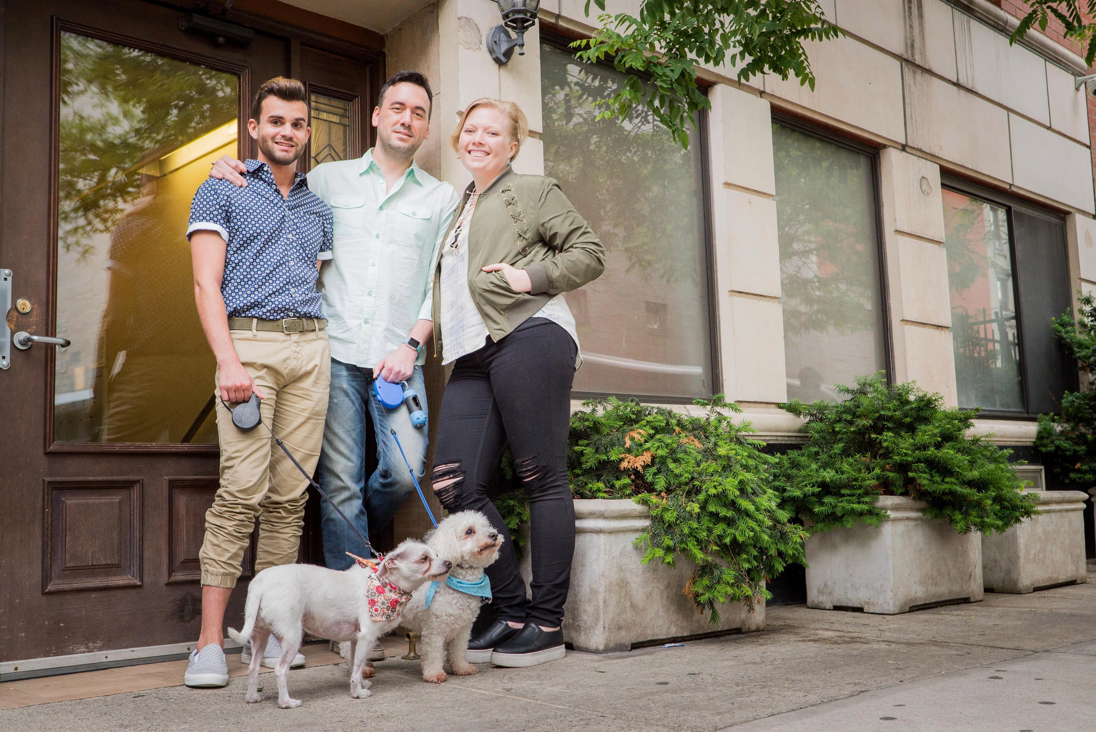  The 'throuple' (L-R Matt, Chris and Cait) outside the apartment they share with their two dogs