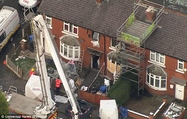 Police officers were searching the property and aerial footage showed scaffolding outside the home