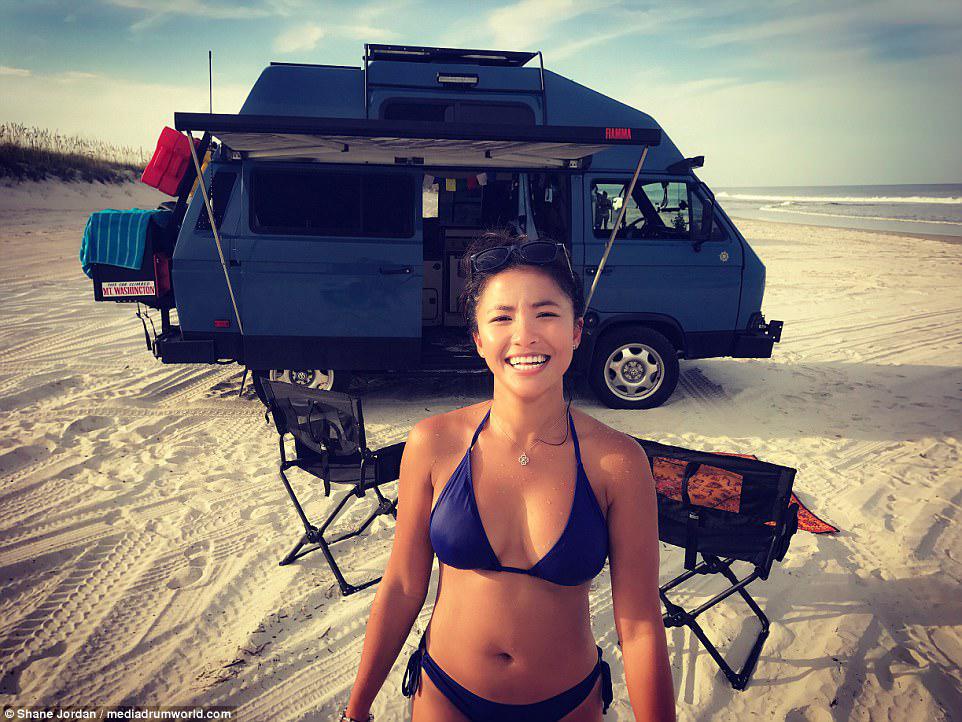 Natalie pictured after enjoying a quick dip in the water, the pair having driven their van on to the beach