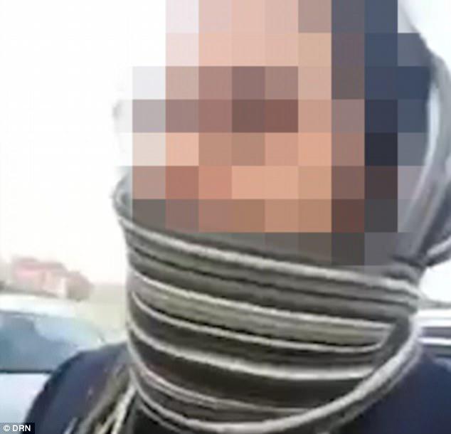 The accused covers his face with a scarf as he is quizzed by the paedophile hunters
