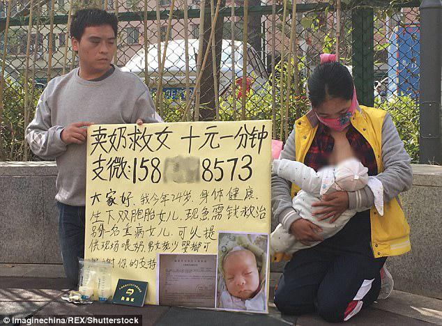 Ms Tang and her husband kneel on the street to beg for strangers' help in China. A signboard says the couple's daughter is sick and the mother is willing to feed other babies to raise money