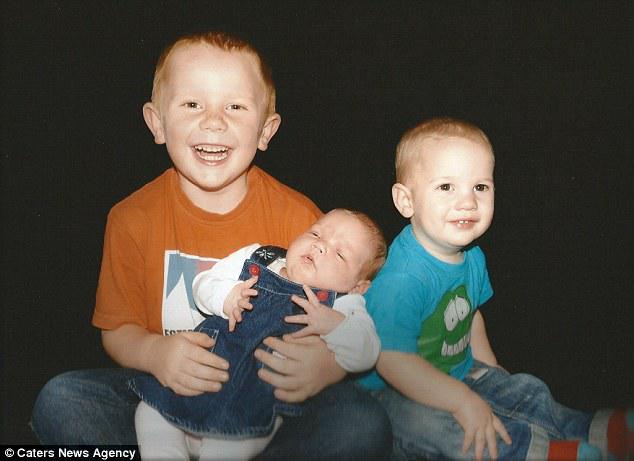 The brothers (pictured with their sister Isobel, now five) have hospital beds next to each other
