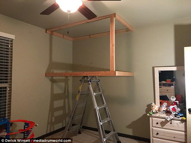 Up it goes: He created ceiling joists to keep the bed sitting five feet above the ground