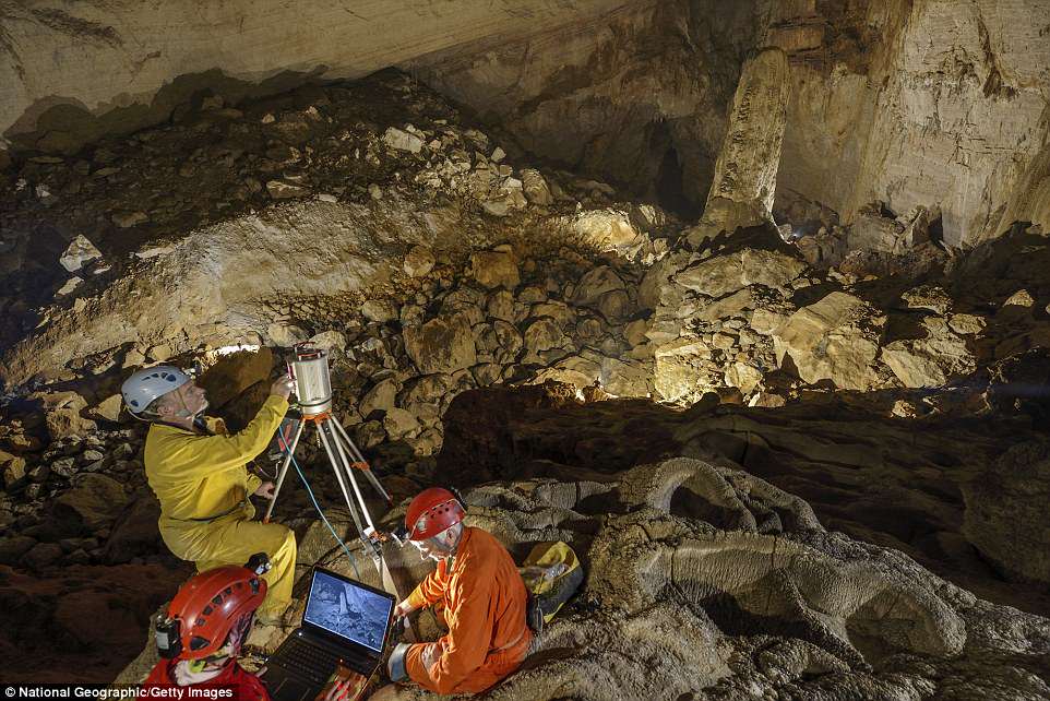 The scanning team downloads data to view a 3-D image of the cave before picking the location for the next scan (file photo)