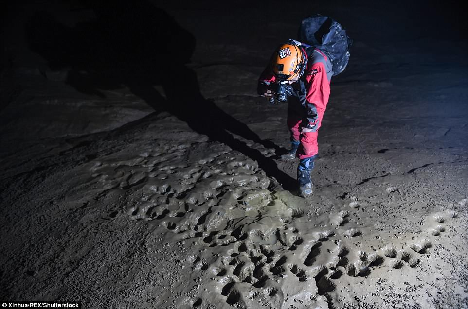 AnÂ expedition member takes pictures of super mud slopes that forms the world's largest cavern