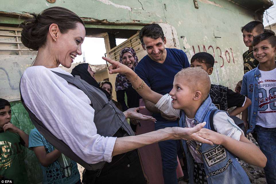 Angelina Jolie has traded the bright lights of LA for war torn Mosul to meet with the victims of Iraq's recent bloody conflict that has claimed the lives of hundreds of thousands.Â The Hollywood star, known for her impressive humanitarian credentials, is a United Nations special envoy and met up with starstruck youngsters and parents as part of her role