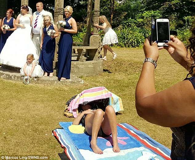 The bikini-clad woman had positioned herself on a towel just yards from where the newlyweds had their photographs taken