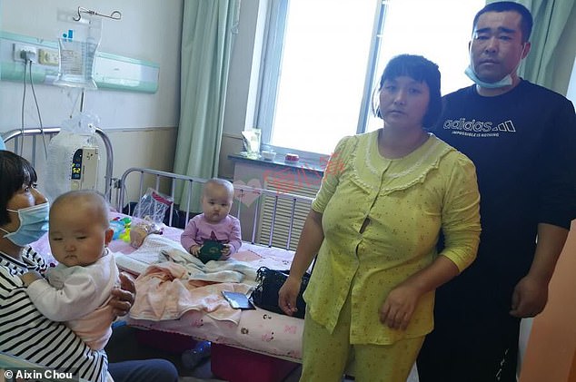 Song Lihua and her partner Ma Xinqiang (right) are pictured in the hospital with their babies