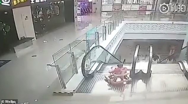 The baby slowly toddles out of the store and towards the escalator with the help of a walker