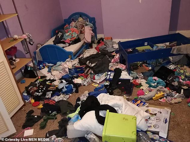 Clutter is left on the bed and the floors in one of the bedrooms in the propertyÂ 